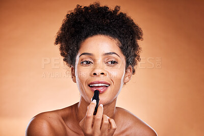 Buy stock photo Black woman, afro and face glow lipstick on studio background for morning grooming routine, self care or satisfaction. Smile, happy or beauty model with lip gloss, makeup cosmetics and color product