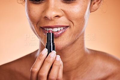 Buy stock photo Makeup, lips and lipstick with a black woman model using cosmetics for her lip in studio on a beige background. Beauty, cosmetic and mouth with a female posing to promote a beautification product
