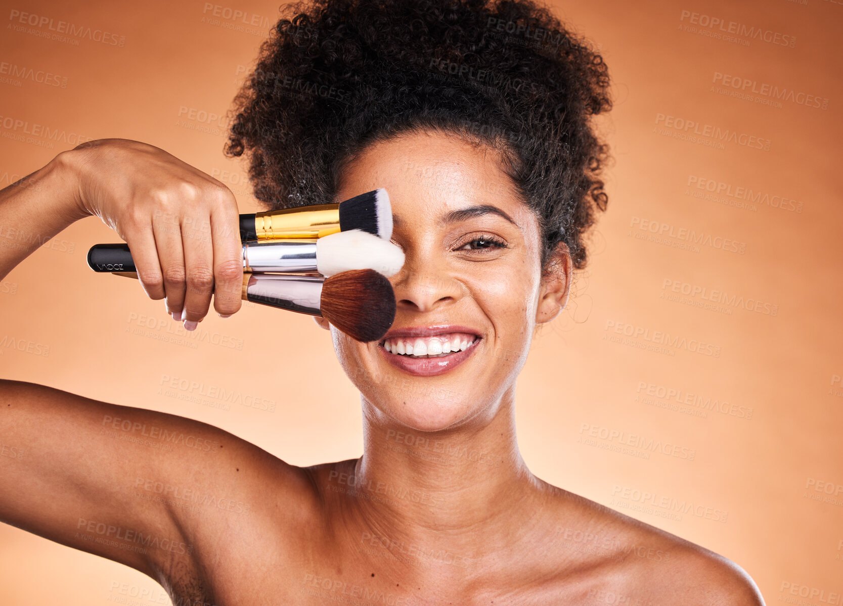 Buy stock photo Beauty, makeup and portrait of black woman with brushes in studio isolated on an orange background. Self care, skincare and female model with cosmetics, products or makeup brushes for skin aesthetic.
