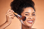 Makeup, brush and black woman in studio for beauty, skincare and cosmetic with smile headshot. Model, cosmetics woman and happy portrait with facial foundation, powder or product by orange background