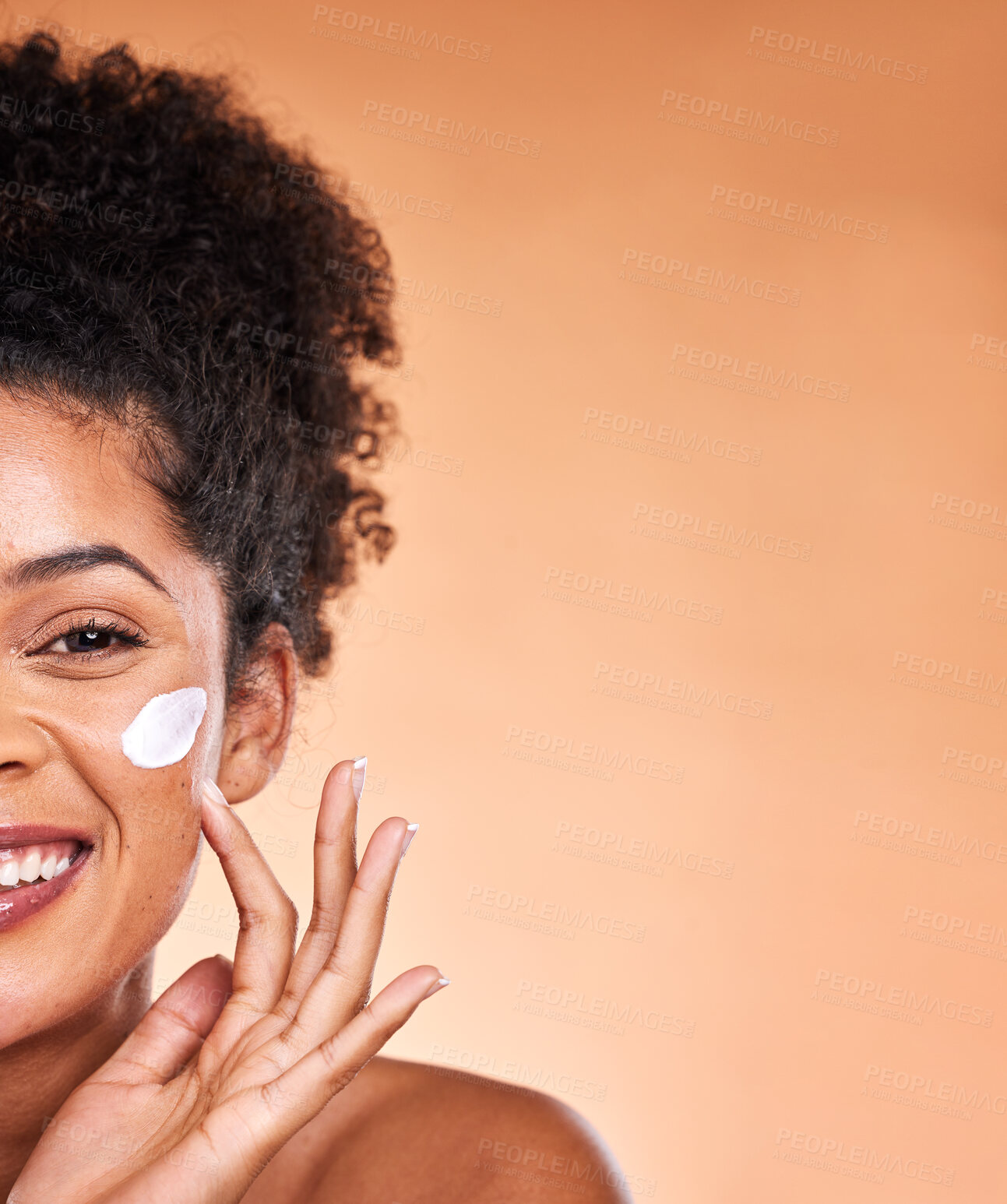 Buy stock photo Skincare, beauty and black woman with facial cream on orange background studio for wellness. Makeup, cosmetics and half face of girl apply lotion, sunscreen and skincare products for dermatology care