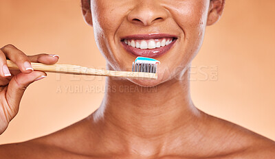 Studio, dental and black woman brushing teeth on orange background. Wellness, oral health or routine of happy female model holding toothbrush and cleaning teeth for hygiene, oral care and dental care