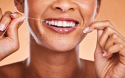 Buy stock photo Woman, hands and teeth with smile for dental floss, skincare or personal hygiene against a studio background. Closeup of female smiling and flossing in cosmetics for oral, mouth or gum care treatment