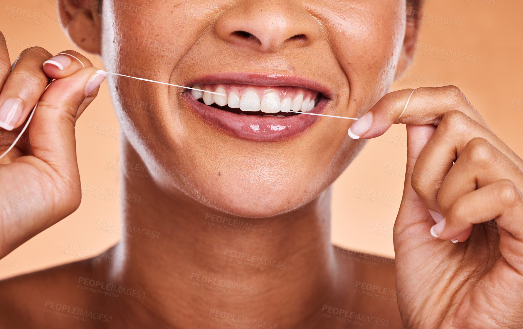 Buy stock photo Woman, hands and teeth with smile for dental floss, skincare or personal hygiene against a studio background. Closeup of female smiling and flossing in cosmetics for oral, mouth or gum care treatment