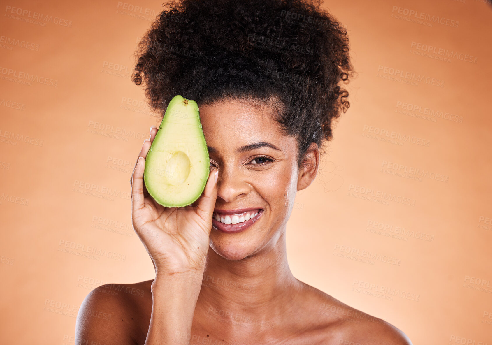 Buy stock photo Beauty, skincare and avocado with a model black woman in studio on a beige background for wellness or antioxidants. Portrait, skin or nutrition with an attractive young female proud of healthy eating