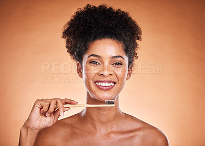 Buy stock photo Dental care, toothbrush and hygiene with a model black woman brushing her teeth in studio on a beige background. Portrait, face and oral treatment with an attractive young female proud of her routine