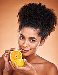 Lemon, skincare and black woman with food to detox against a brown studio background. Marketing, vitamin c and portrait of an African model advertising fruit for natural beauty, skin and nutrition 