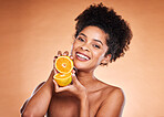 Skincare, beauty and portrait of black woman with lemon on orange background in studio. Wellness, cosmetics and girl with fruit advertising natural, organic and healthy skincare products for spa