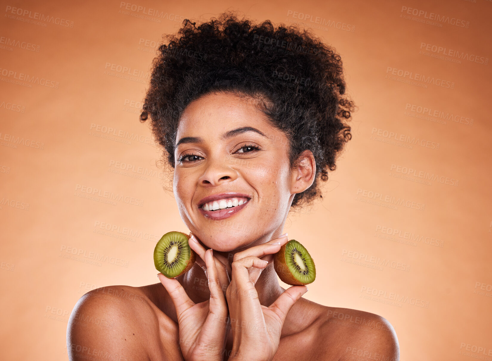 Buy stock photo Kiwi fruit, beauty and black woman healthcare or vitamin c nutrition for skincare health. Portrait of African girl model, diet wellness or healthy cosmetics and facial care in brown background studio