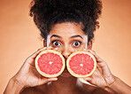 Black woman, skincare and grapefruit cosmetic for skin with vitamin c treatment, facial citrus health and natural wellness. Wow surprise eyes, healthcare model and healthy diet nutrition advertising 