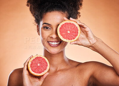 Buy stock photo Grapefruit, skincare and black woman in studio portrait for beauty, cosmetics and vegan promotion, marketing or advertising. Healthy food, red fruits and face or headshot of model for vitamin c glow