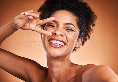 Buy stock photo Woman, peace sign and selfie in skincare, beauty or cosmetics against a studio background. Portrait of happy black woman face with hand gesture smiling for perfect facial skin treatment or photo