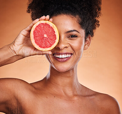 Buy stock photo Grapefruit, black woman and beauty, skincare and wellness, healthy body and vitamin c, natural cosmetics and afro on studio background. Portrait of happy african model, citrus fruits and detox diet 