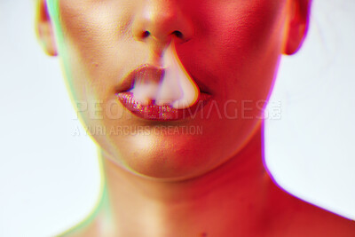 Buy stock photo Beauty, cosmetics and woman lips with smoke with neon red lighting in studio on white background. Creative, artistic and half face of girl with makeup, lipstick and cyber aesthetic for smoking vape