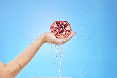 Buy stock photo Pomegranate, water and hand on studio background mockup for skincare, detox and beauty product marketing, advertising or promotion. Red fruit, healthy food and shower water drop splash for vitamin c