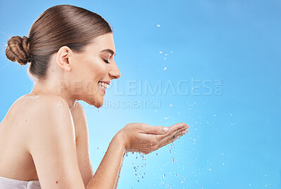 Buy stock photo Profile, skincare and water splash of woman in studio isolated on a blue background mockup. Hygiene, cleaning and female model washing face for health, wellness and beauty or body care with mock up

