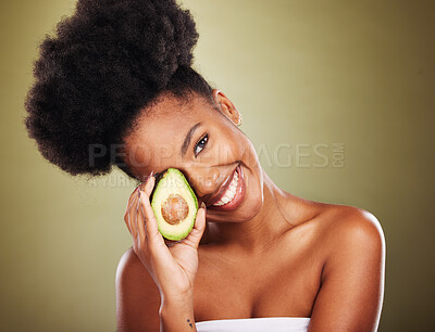 Buy stock photo Black woman, skincare and beauty in studio with avocado for health, nutrition or moisturizer for wellness. Woman, model and fruit for radiant glow skin, shine and healthy against cosmetics background