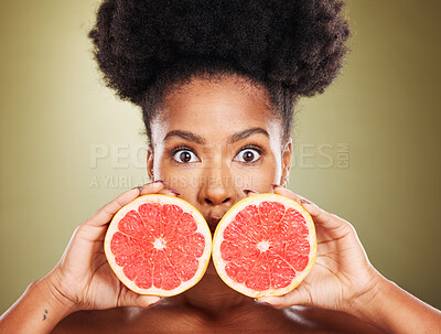 Buy stock photo Face portrait, skincare and black woman with grapefruit isolated on a green studio background. Surprise, wow and female model holding healthy fruit for natural vitamin c, facial care or skin wellness