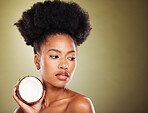 Coconut, beauty and black woman in studio for natural hair care, skincare and healthy product marketing or advertising mockup. African model with coconut oil cream for skin care glow or hair growth