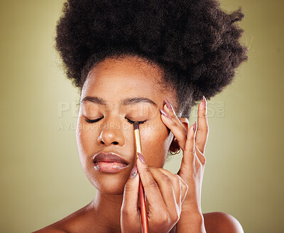 Buy stock photo Black woman, eyeshadow makeup and brush in studio on green background. Skincare, self care and young female model holding makeup brush, cosmetics or eyeliner product for beauty aesthetics or wellness