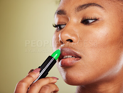 Buy stock photo Lipstick, black woman and mouth, makeup and skincare, cosmetics and aesthetics on green studio background. African model face, advertising beauty product and lip color, luxury fashion and lip balm 
