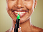 Lipstick, mouth and lips with black woman and beauty closeup, lip care and cosmetic product against studio background. Face, makeup and wellness with glowing skin and natural cosmetics with smile.