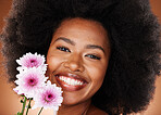 Black woman, face or afro hair with daisy flowers on studio background for gentle skincare, vibrant glow or organic dermatology. Zoom, portrait or happy smile beauty model with natural hair and plant