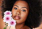 Flower, skincare and black woman natural hair in a studio portrait for beauty, cosmetics and eco friendly product promotion. Young african model face with daisy floral skin, hair care and self love