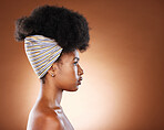 Hair care, afro and profile of black woman in studio with mockup space by brown background. Clean, healthy and young African model with beautiful natural curly hair with copy space for advertisement.