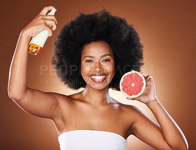 Buy stock photo Grapefruit, black woman and afro hair spray, beauty and serum in hair care maintenance, aesthetic wellness or natural cosmetics on studio background. Portrait african model, citrus oil and curly hair