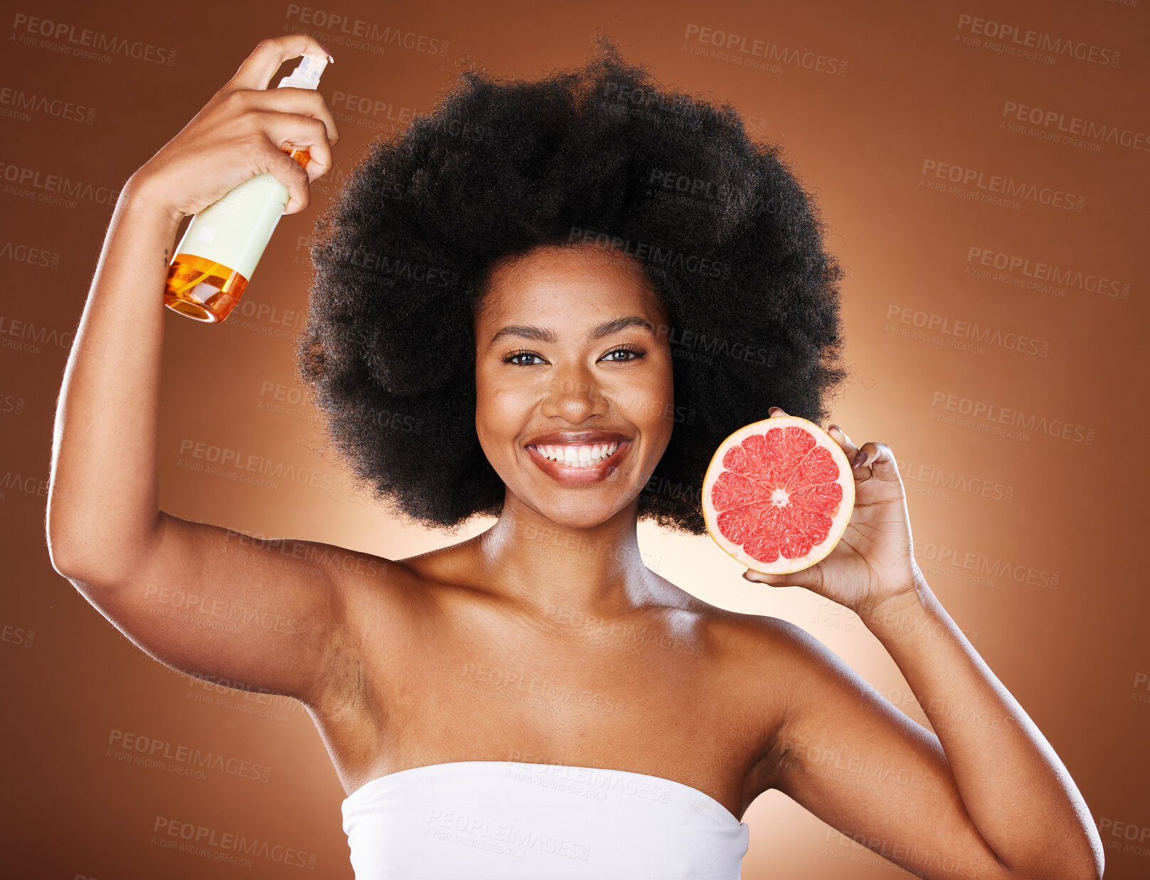 Buy stock photo Grapefruit, black woman and afro hair spray, beauty and serum in hair care maintenance, aesthetic wellness or natural cosmetics on studio background. Portrait african model, citrus oil and curly hair