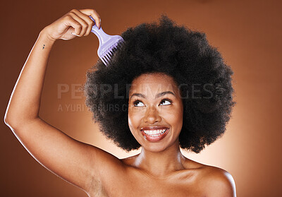 Beauty, hair care and black woman with afro comb in studio isolated on a  brown background. Afro hair, wellness and happy female model with hair tool  for hairstyle, salon treatment or healthy