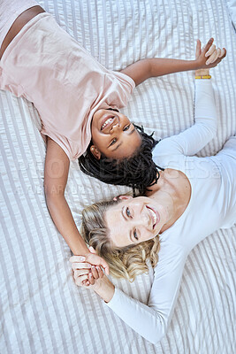 Buy stock photo Diversity, love and family together in bedroom for quality time or adoption care, support and happiness. Happy family, diverse mother and daughter portrait on bed for relax, calm and funny bonding