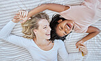 Mother, girl and bed fun after adoption or foster with love and care in a bedroom with happiness. Family care, funny and happy time of a mama and child together with a smile, gratitude and laughing