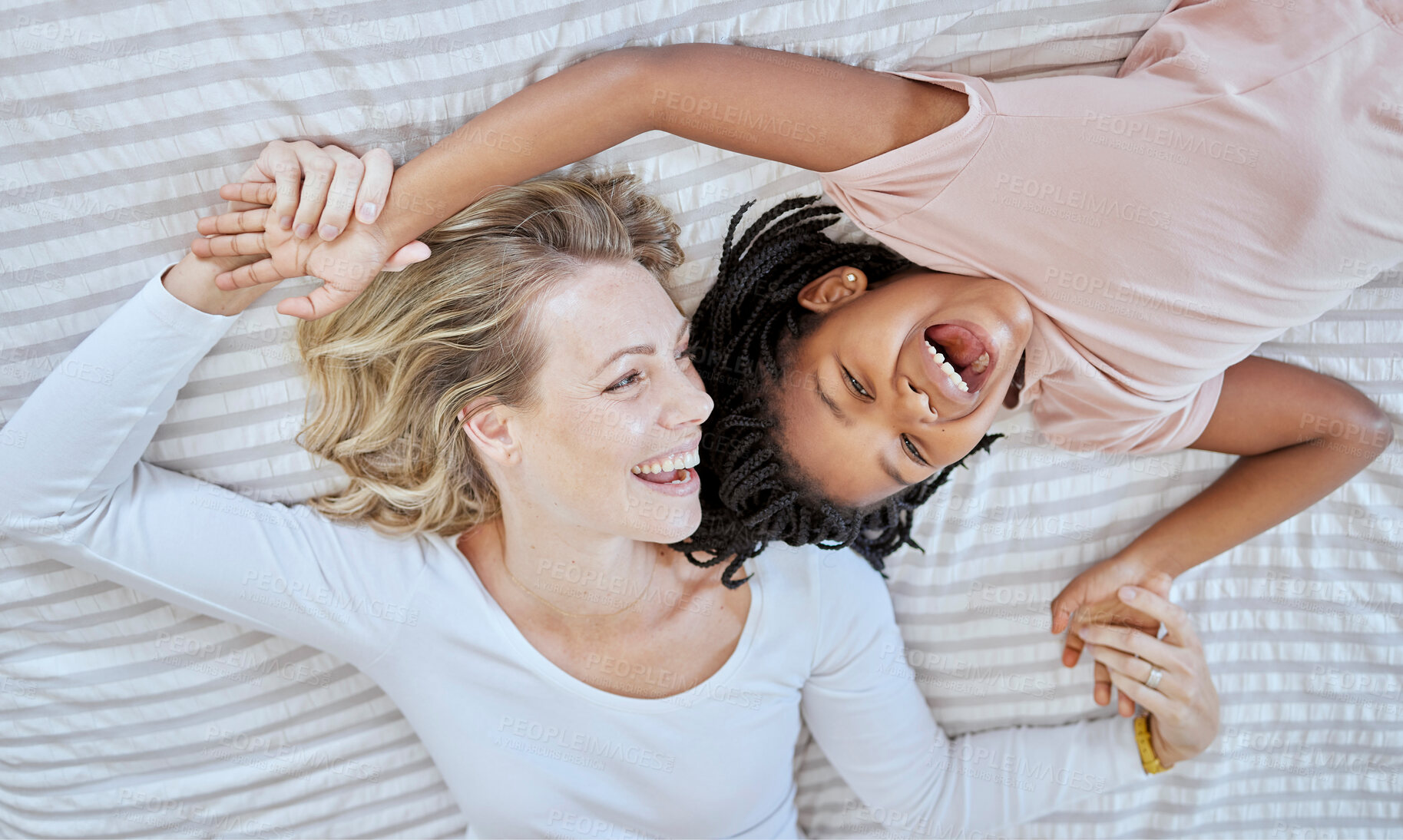 Buy stock photo Mother, girl and bed fun after adoption or foster with love and care in a bedroom with happiness. Family care, funny and happy time of a mama and child together with a smile, gratitude and laughing