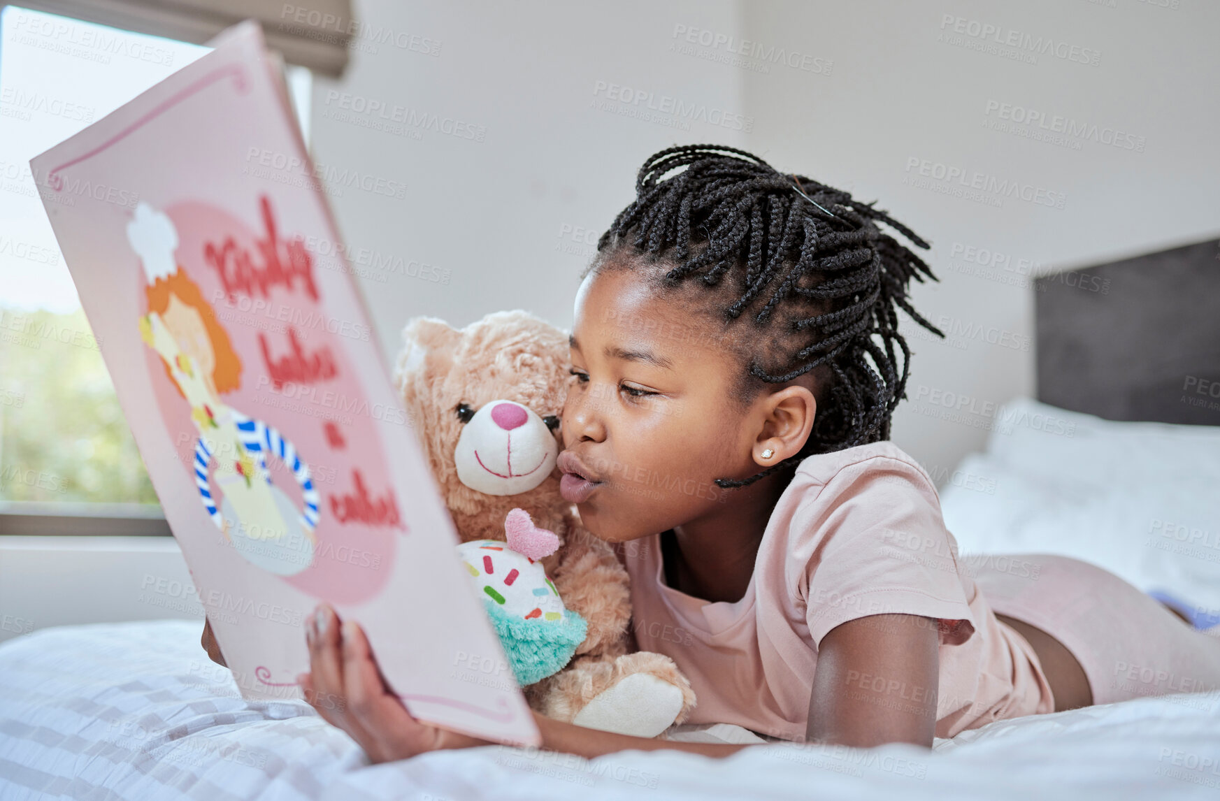 Buy stock photo Reading, book and teddy bear with a black girl in bed, lying down to relax in the bedroom with her hobby. Children, books and education with a female kid telling her teddybear a story in their home