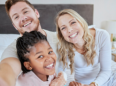 Buy stock photo Love, adoption and selfie portrait of happy family mother, father and black child relax in home bedroom for morning fun. Happiness, smile and photo memory of modern diversity people, parents and kid