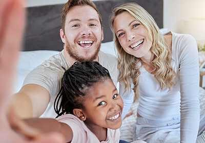 Buy stock photo Family, adoption and selfie portrait, love and smile together on bed in the morning, support and happy in home.  Black girl, father and mother smile for social media photo or picture  in bedroom