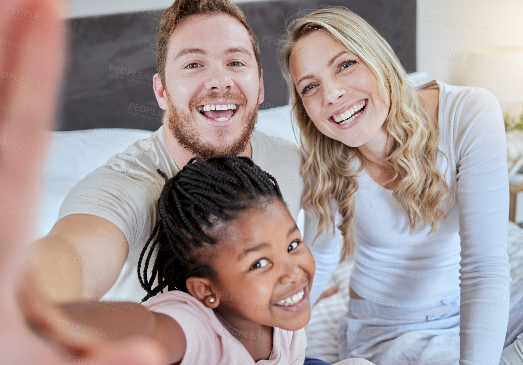 Buy stock photo Family, adoption and selfie portrait, love and smile together on bed in the morning, support and happy in home.  Black girl, father and mother smile for social media photo or picture  in bedroom