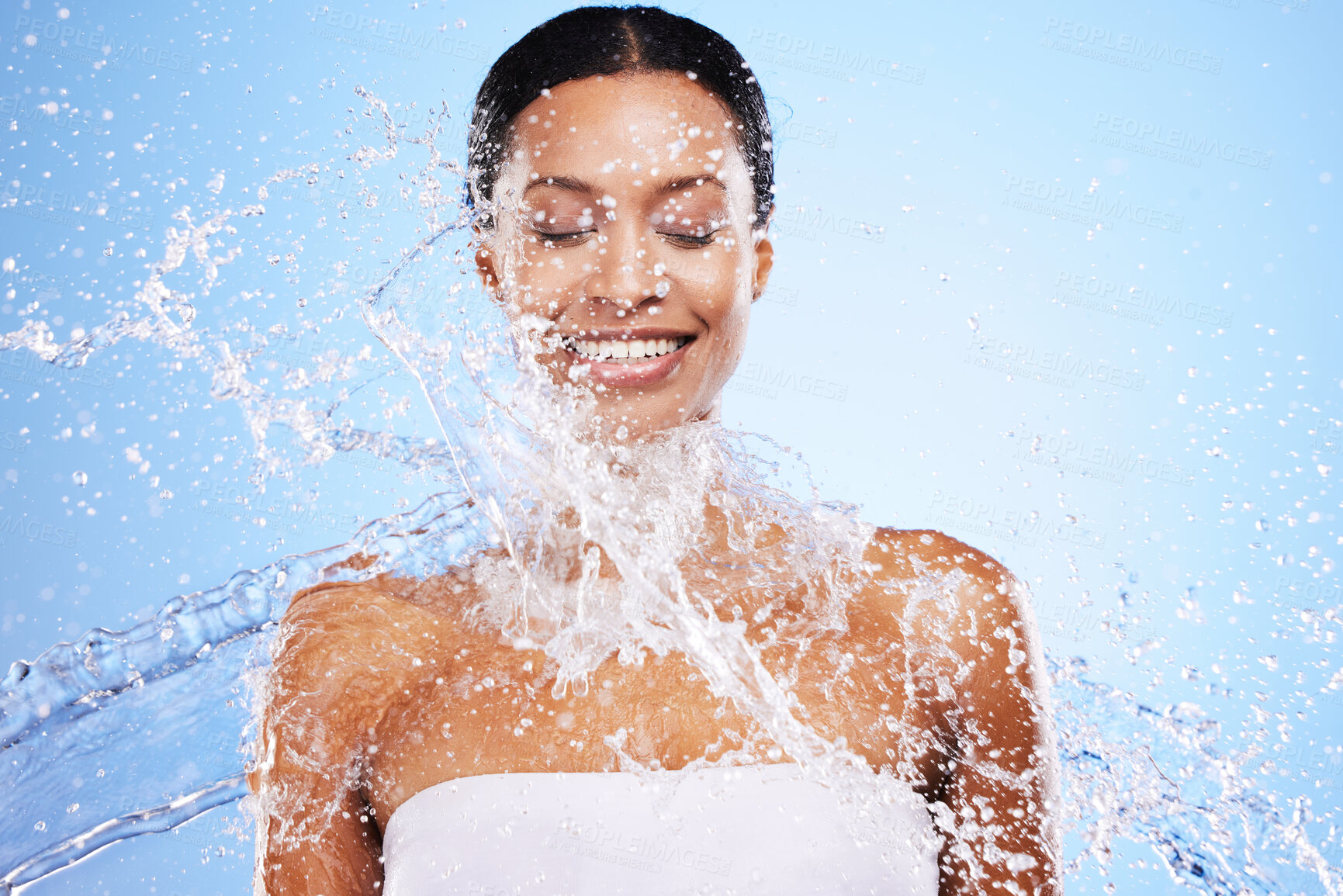 Buy stock photo Water splash, black woman and beauty on blue background, skincare hydration and facial wellness, body care and shower, cleaning and personal hygiene. Young studio model, water drop and dermatology  