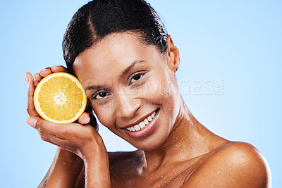 Buy stock photo Skincare, beauty and orange fruit for black woman in studio for cosmetics, vitamin c and dermatology benefits with water drops on skin. Portrait, face and smile of model with natural product for skin