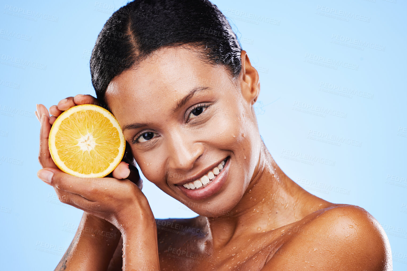 Buy stock photo Skincare, beauty and orange fruit for black woman in studio for cosmetics, vitamin c and dermatology benefits with water drops on skin. Portrait, face and smile of model with natural product for skin