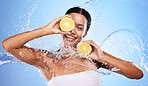 Water splash, lemon and skincare with beauty, product and advertising body wellness, cleaning and hygiene in blue studio background. Health, clean or skin with an young female model and natural fruit