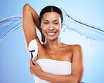 Shaving, water and portrait of woman on blue background in studio for body care, wellness and grooming. Healthcare, beauty and black woman with water splash, razor and shaving cream or foam on armpit