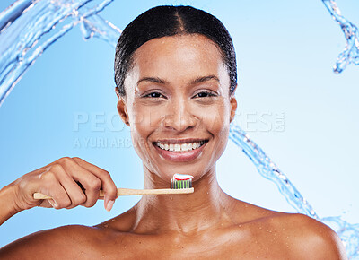Buy stock photo Toothpaste product, toothbrush and black woman, dental cleaning and water splash in blue studio background. White teeth, healthy mouth and hygiene with beauty advertising, oral smile and mouth health