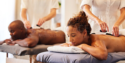Buy stock photo Couple massage, rock or spa therapist for relax, luxury or wellness treatment for health, self care or zen at resort. Healthcare, beauty salon or black woman and man for healthy, skincare or therapy