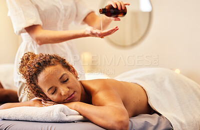 Buy stock photo Spa, luxury massage and woman with essential oil getting back massage for wellness in beauty salon. Health, beauty and black woman with massage therapist for relaxation, stress relief and body care