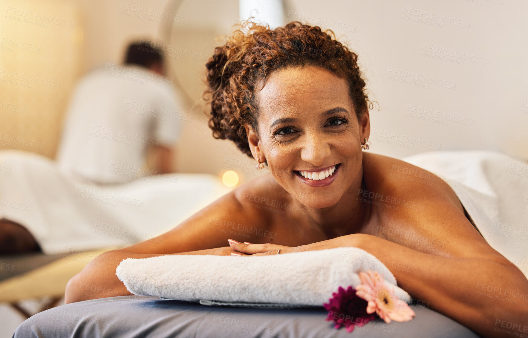 Buy stock photo Black woman, smile and relax in massage at spa for cosmetic skincare or beauty treatment at a resort. Portrait of African American female lying on massaging table or bed smiling for luxury wellness