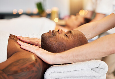 Buy stock photo Massage, spa and black man with therapist hands, relax and skincare with zen, peace and wellness on bed. Physical therapy, healing and body therapy, relaxing and luxury treatment with therapist hand