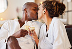 Black couple kiss at spa for wellness, champagne and love with romance for stress relief, celebration of relationship and bonding. Black man, black woman and anniversary getaway, toast with drink.